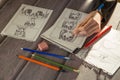 Artist drawing an anime comic book in a studio. Wooden desk, natural light. Creativity and inspiration concept Royalty Free Stock Photo