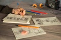 Artist drawing an anime comic book in a studio. Wooden desk, natural light. Creativity and inspiration concept