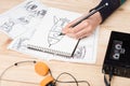 Artist drawing an anime comic book in a studio. Wooden desk, natural light. Creativity and inspiration concept