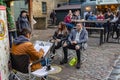 Artist drawing caricatures of an British couple in Camden Lock Market or Camden Town in London,