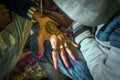 Artist drawing henna pattern on woman hand,