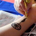 Artist drawing henna, Indian mehndi