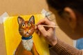 The artist draws with acrylic paints a drawing of a cat on an easel, close-up Royalty Free Stock Photo