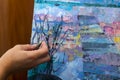 The artist draws with a palette knife close-up Royalty Free Stock Photo