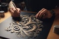 The artist draws a pattern on a black sheet of paper with a brush, Embrace the art of elegant lettering in the enchanting world of