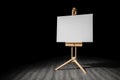 Artist easel with blank canvas background at art gallery exhibition