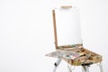 Artist easel with blank canvas on a white background.