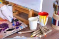 Artist extrudes paint from tubes on palette for mixing colors t Royalty Free Stock Photo