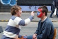 Artist Face Painter at Work in City Street Royalty Free Stock Photo