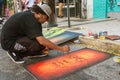 Artist Flicks Yellow Paint Onto Painting At Arts Festival