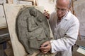 Artist gesture on a clay sculpture in the arts studio