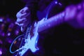 Artist Guitarist hand play electricity guitar on concert stage with blue light, Practicing in playing . song