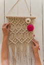 Artist hands holding macrame wall art