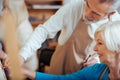 Artist helping his female colleague in painting class Royalty Free Stock Photo