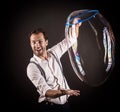 Artist hold big soap bubble in his hands. Royalty Free Stock Photo