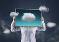 Artist holding an picture with clouds flying away from the frame , on a dramatic sky in background. The concept of fulfilling