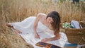 Artist lady drawing sketch notebook meadow picnic. Smiling woman laying blanket Royalty Free Stock Photo