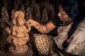 An artist makes idols of Lord Ganesha