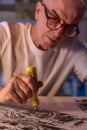 Artist middle-aged man painting or drawing digitally