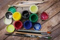 Artist paint brushes and jars with acrylic paint on wooden background.Painting hobby background. Paintings art concept. Royalty Free Stock Photo