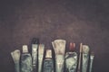 Artist paintbrushes, paint tubes closeup on dark canvas background. Royalty Free Stock Photo