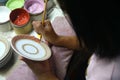 Artist painting benjarong ceramic ware