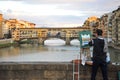 Artist painting the bridges of Florence city , Italy