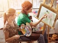 Artist painting on easel in studio. Authentic children paints . Royalty Free Stock Photo