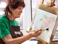 Artist painting easel in studio. Authentic grandmother and kids. Royalty Free Stock Photo