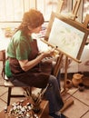 Artist painting easel in studio. Authentic senior woman. Royalty Free Stock Photo