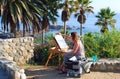 An artist painting in Heisler Park, Laguna Beach, CA