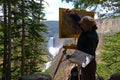Artist painting landscape with waterfall