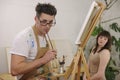 Artist painting model at art studio