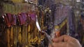 An artist painting with a palette knife in studio