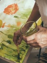 Artist painting picture on canvas with watercolours