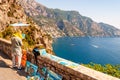 The artist painting scenery of a beautiful Positano city coast scenic rocky surroundings on one of a cliffs with blue sea waters