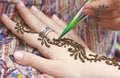 Artist painting traditional indian henna tattoo on woman hand Royalty Free Stock Photo