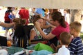 An artist paints the face of a child