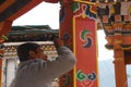 An artist that paints flowers and patterns on a pillar of a house in Bhutan