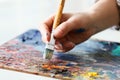 Artist paints a picture of oil paint brush in hand with palette Royalty Free Stock Photo