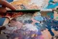 Artist paints a picture of oil paint brush in hand with palette closeup Royalty Free Stock Photo