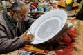 Artist paints unfired pottery