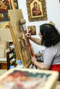 Artist paiting icons in icon painting studio in Kalabaka, Greece Royalty Free Stock Photo