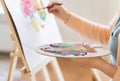 Artist with palette and brush painting at studio Royalty Free Stock Photo