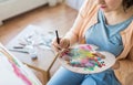 Artist with palette and brush painting at studio Royalty Free Stock Photo