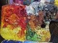 Artist palette full with colorful oil paint