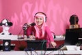 Artist with pink hair mixing techno song with electronic using professional turntables