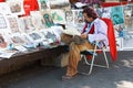 The artist placed in the town square and draws caricatures of people.