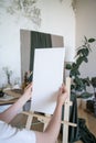 The artist places a white canvas on an easel. Hobbies, drawing. Preparing tools Royalty Free Stock Photo