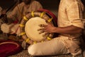 An artist playing with Thavil instrument